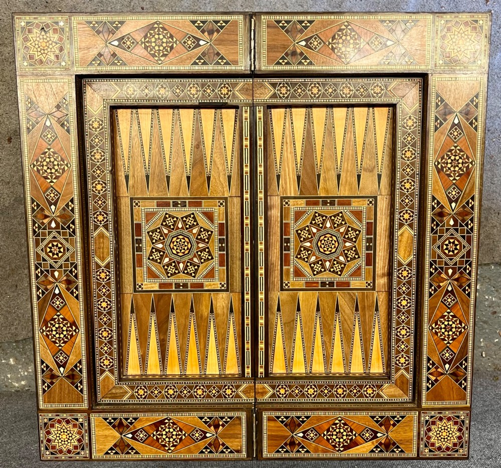 A Syrian games table featuring geometric micro-mosaic wood inlay, curved cabriole legs, and a fitted lower shelf. View VII