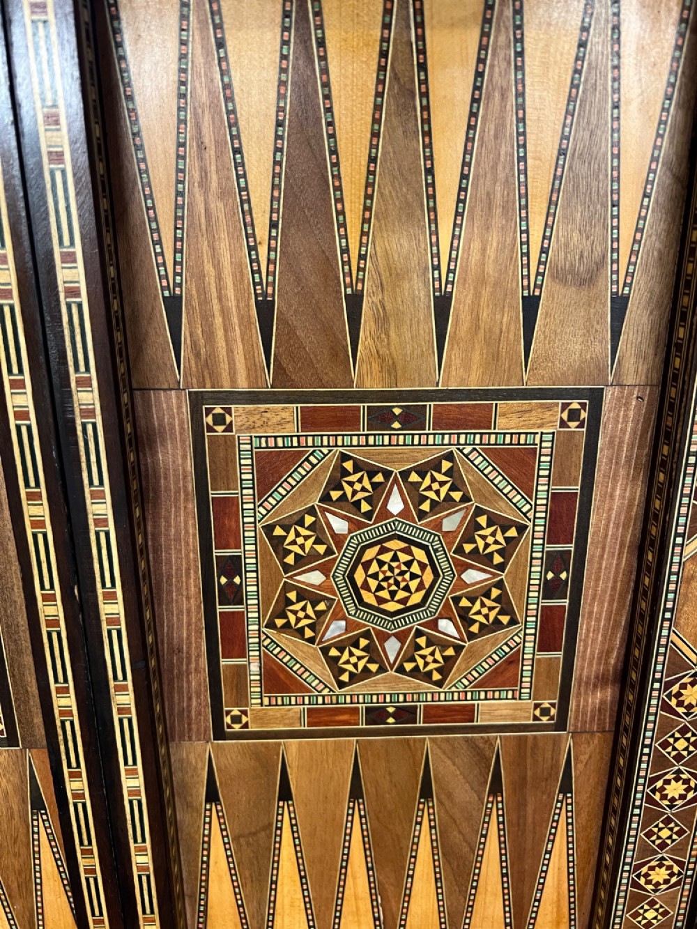 A Syrian games table featuring geometric micro-mosaic wood inlay, curved cabriole legs, and a fitted lower shelf. View VIII