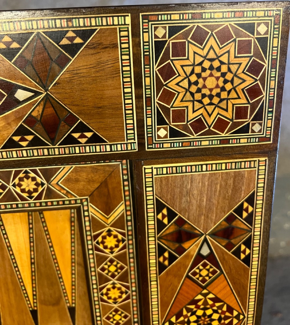 A Syrian games table featuring geometric micro-mosaic wood inlay, curved cabriole legs, and a fitted lower shelf. View IX