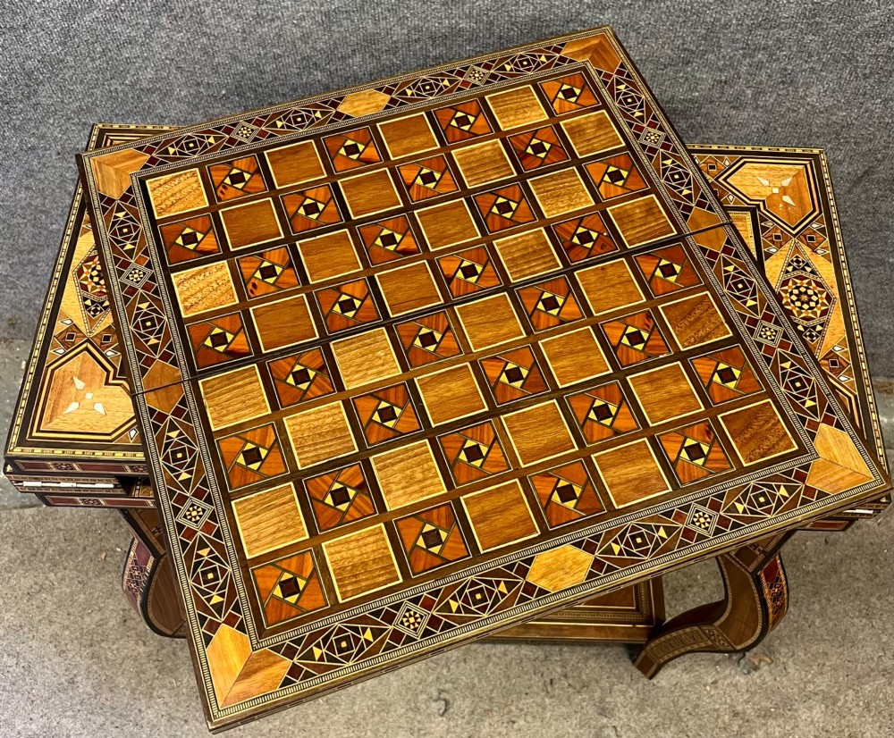 A Syrian games table featuring geometric micro-mosaic wood inlay, curved cabriole legs, and a fitted lower shelf. View X