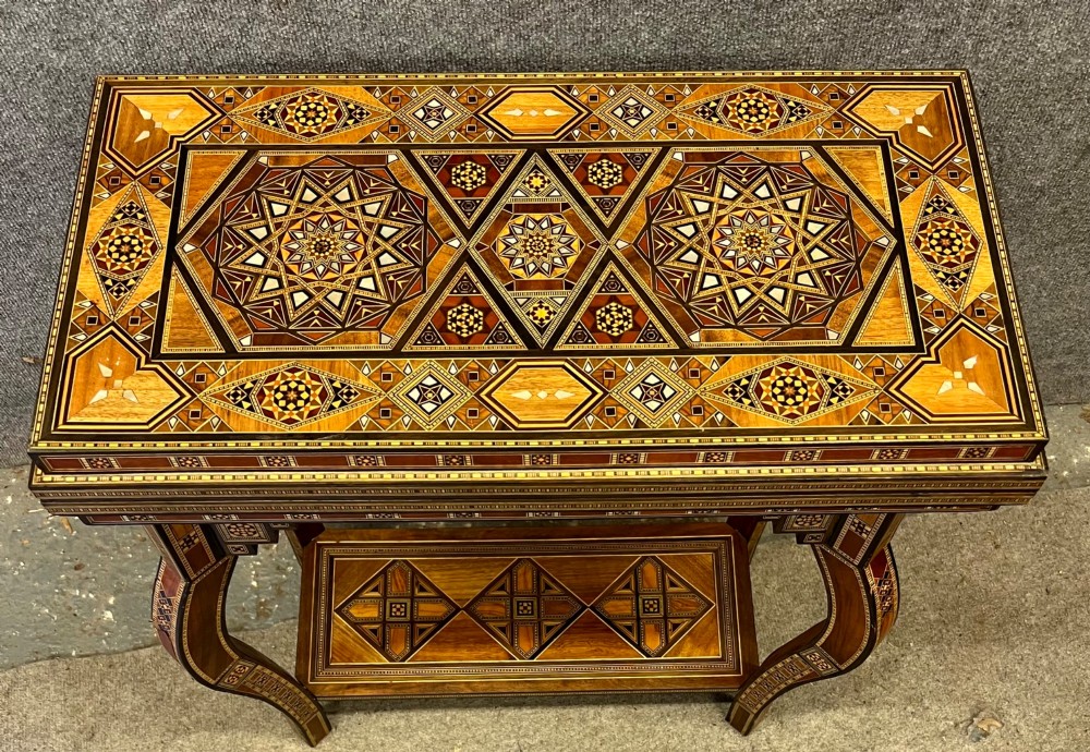 A Syrian games table featuring geometric micro-mosaic wood inlay, curved cabriole legs, and a fitted lower shelf. View XI