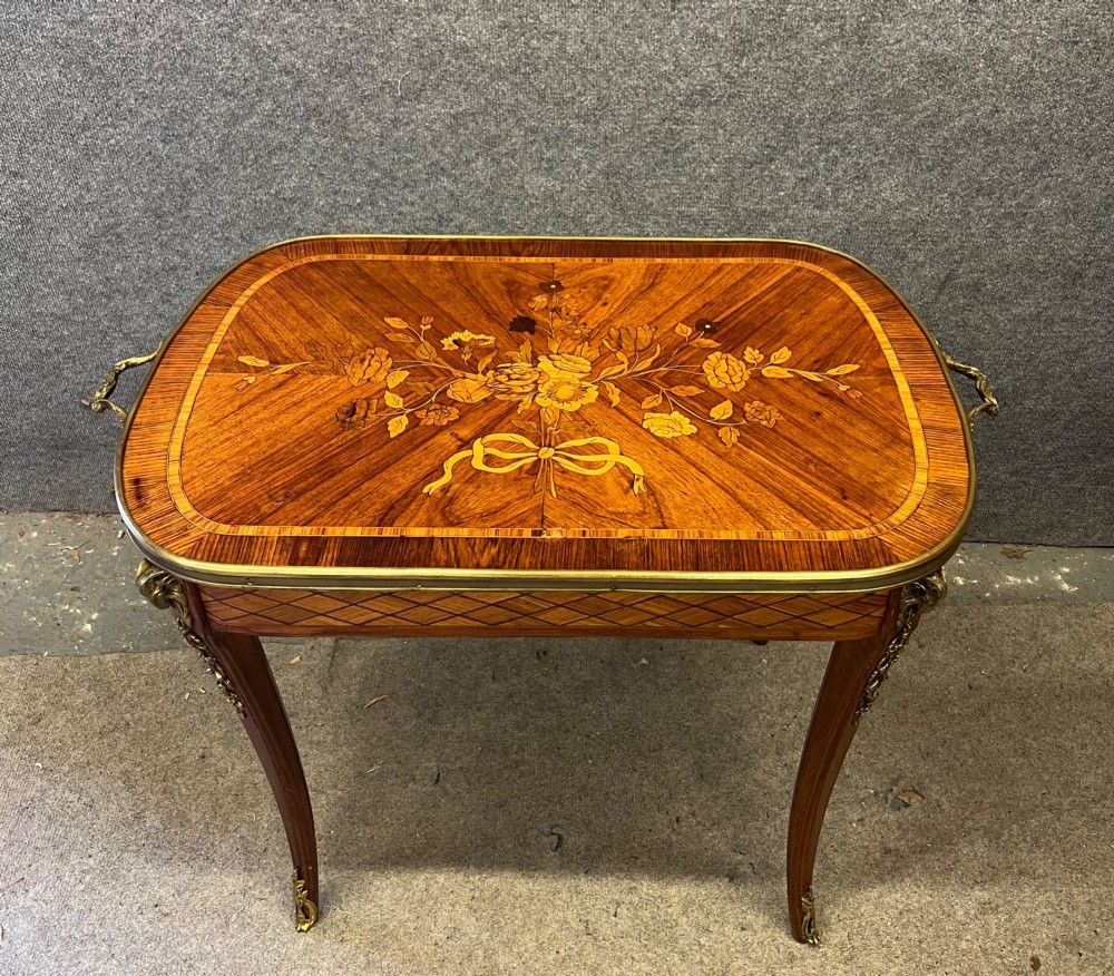 A French style low coffee table featuring floral marquetry inlay on top, diamond parquetry sides, cabriole legs, and brass corner mounts. View II