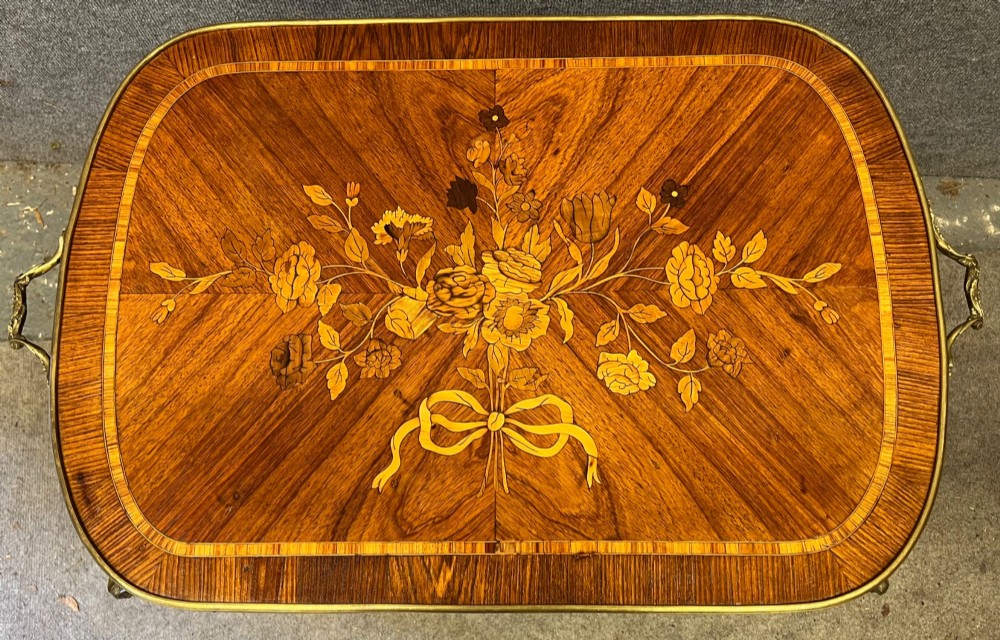 A French style low coffee table featuring floral marquetry inlay on top, diamond parquetry sides, cabriole legs, and brass corner mounts. View III