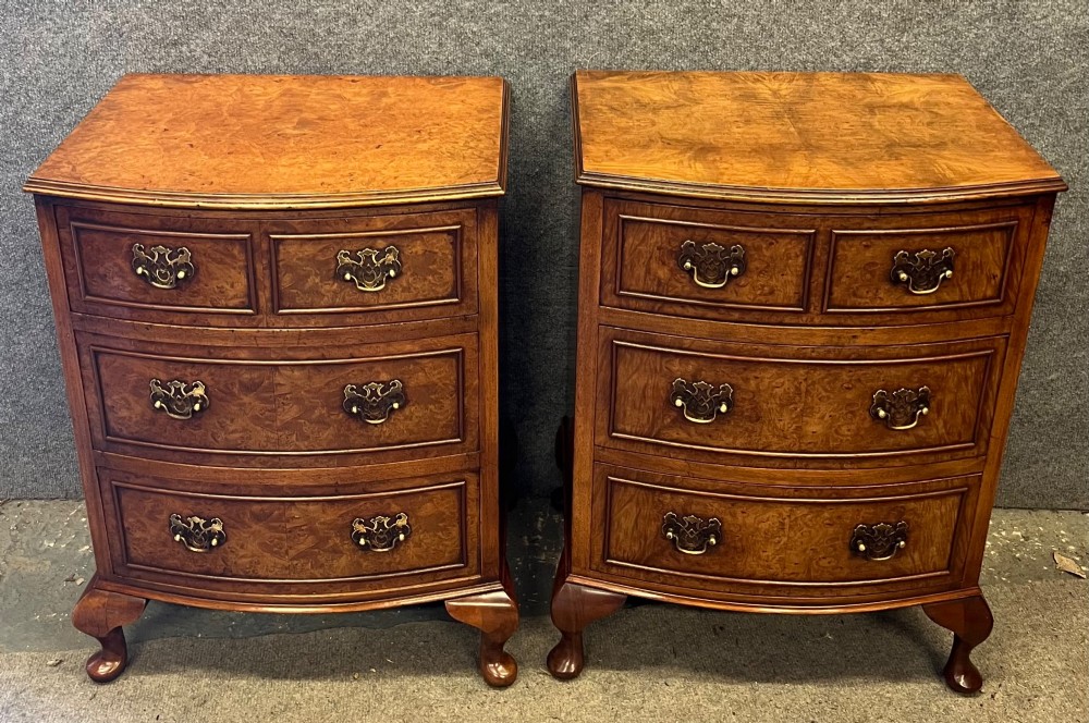 A matching pair of burr walnut bow-fronted bedside chests featuring four drawers with brass handles and cabriole legs. View II