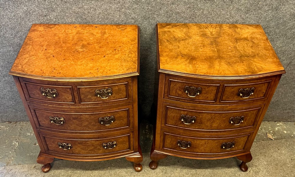 A matching pair of burr walnut bow-fronted bedside chests featuring four drawers with brass handles and cabriole legs. View III