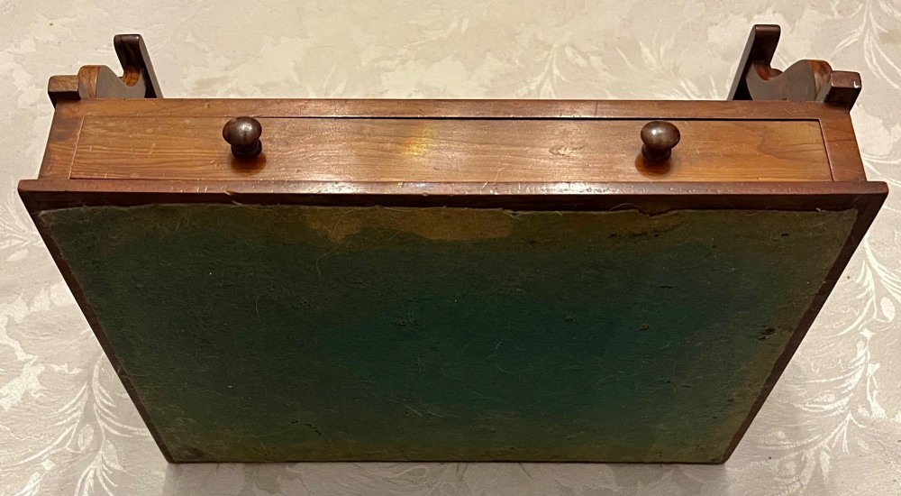 An antique yew wood desktop book trough featuring turned spindle gallery railings on three sides and a smooth timber base. View IV