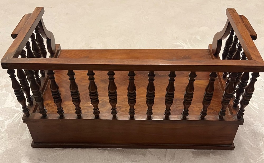 An antique yew wood desktop book trough featuring turned spindle gallery railings on three sides and a smooth timber base. View IX