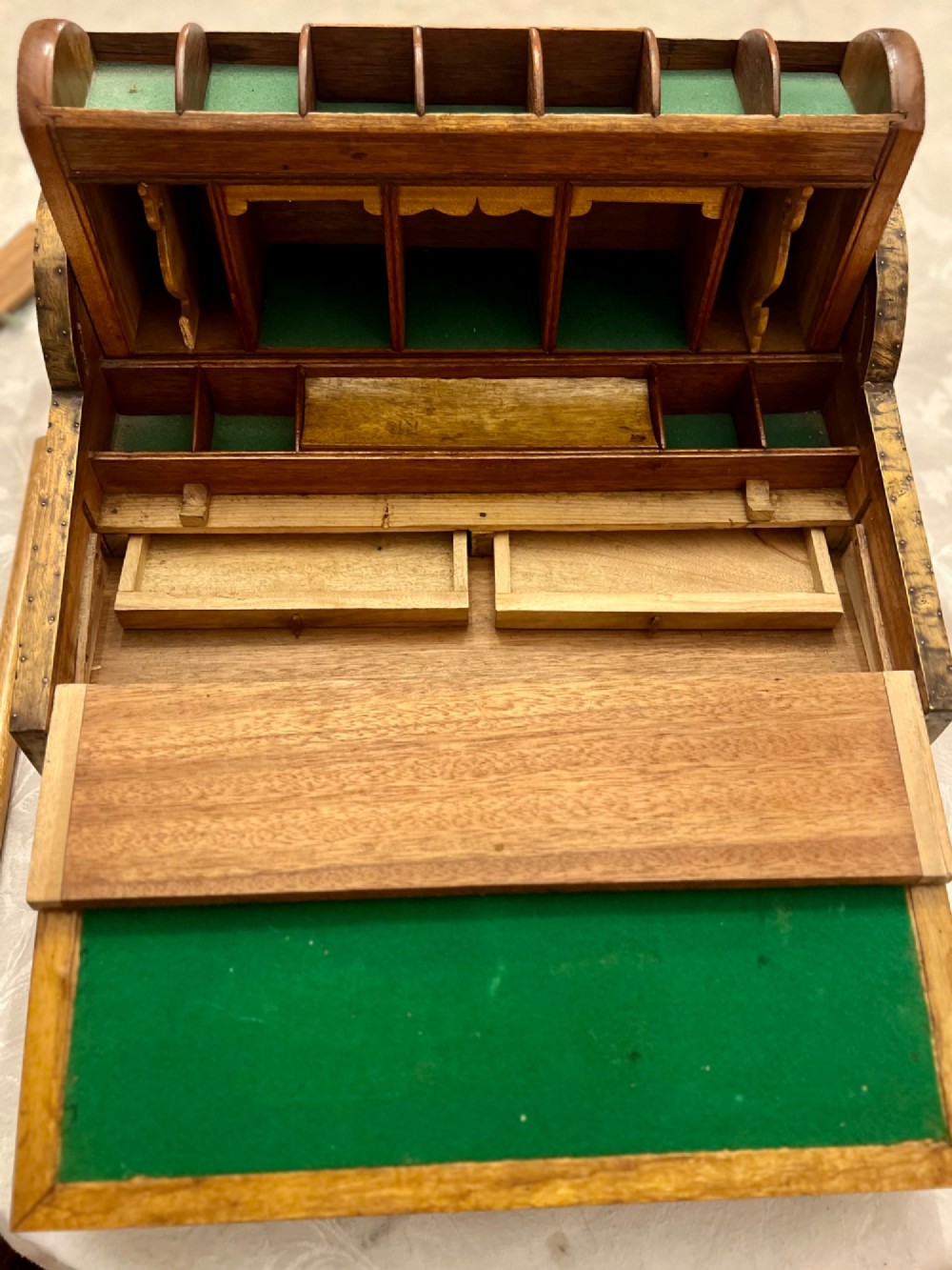 An Anglo Indian camphorwood campaign writing box featuring a ribbed tambour top section, protective brass corner strapping, geometric inlay, and a central brass plaque. View III