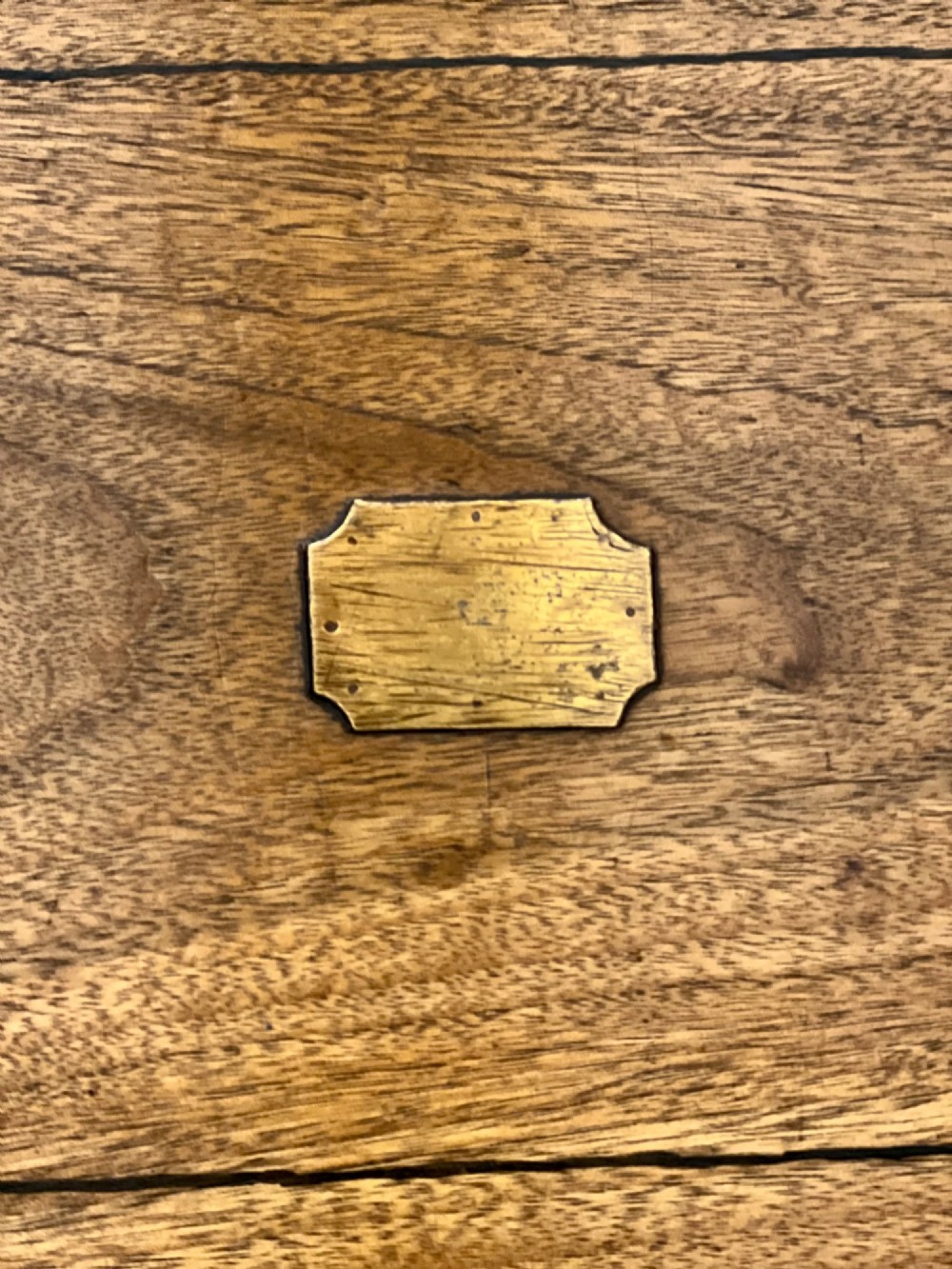 An Anglo Indian camphorwood campaign writing box featuring a ribbed tambour top section, protective brass corner strapping, geometric inlay, and a central brass plaque. View VI