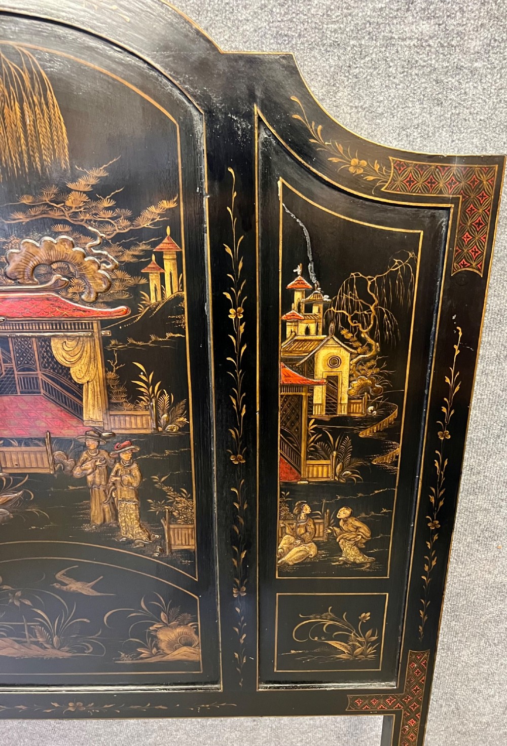 A black lacquered single bedstead featuring hand-painted gold Chinoiserie architectural scenes, arched top panels, and carved cabriole legs. View III