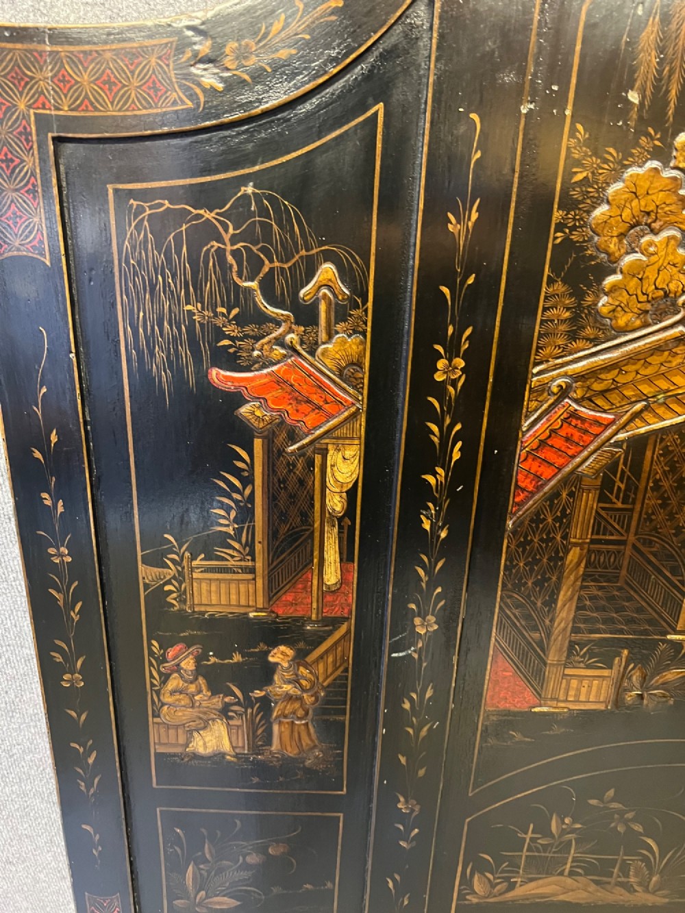 A black lacquered single bedstead featuring hand-painted gold Chinoiserie architectural scenes, arched top panels, and carved cabriole legs. View VII