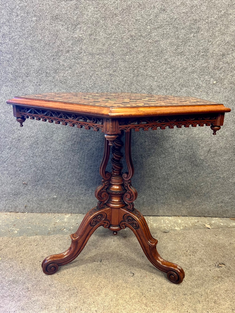 A 19th-century hexagonal specimen wood table featuring a geometric optical illusion parquetry top set on a carved central pedestal base. View V