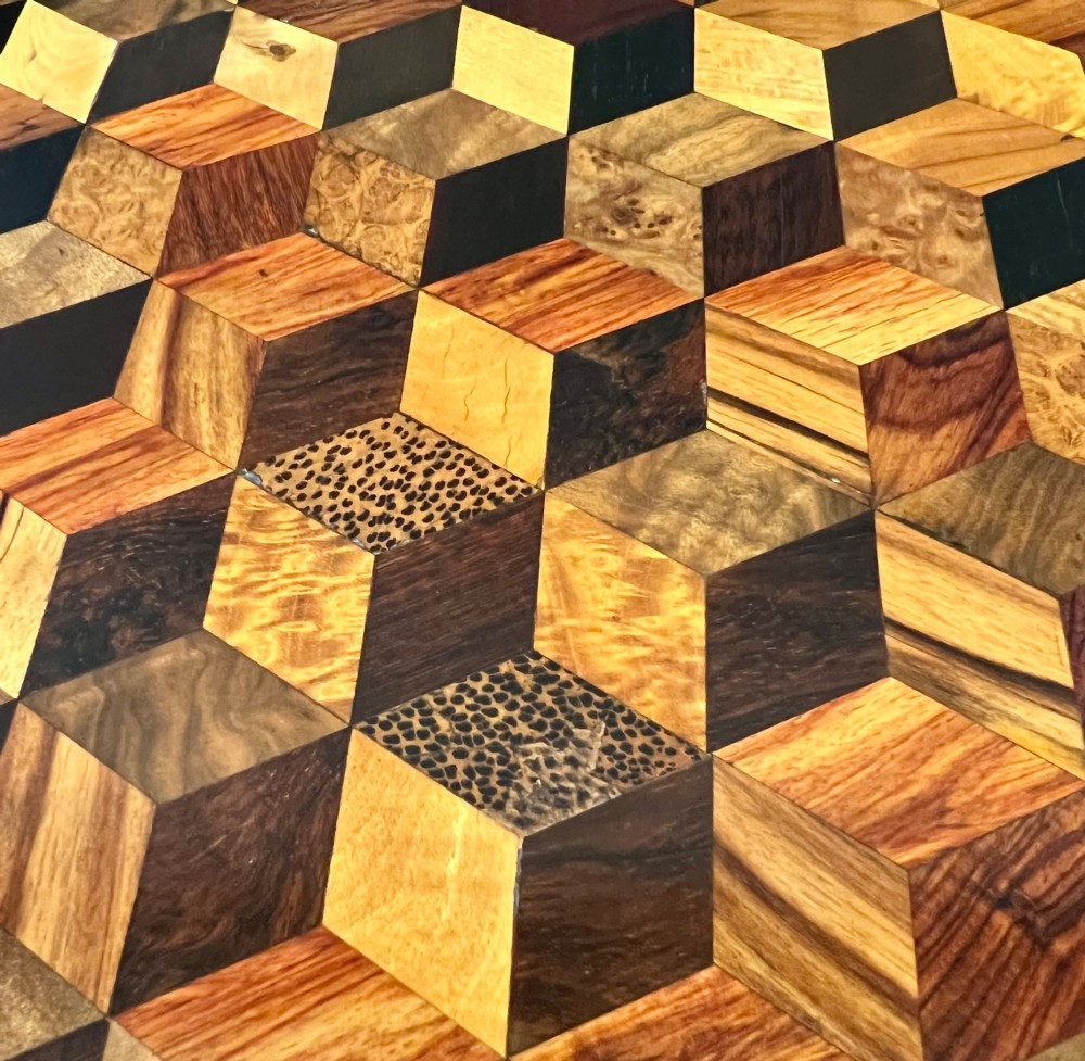 A 19th-century hexagonal specimen wood table featuring a geometric optical illusion parquetry top set on a carved central pedestal base. View XI