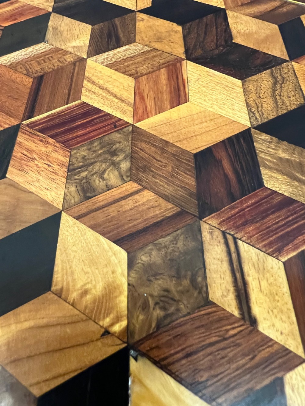 A 19th-century hexagonal specimen wood table featuring a geometric optical illusion parquetry top set on a carved central pedestal base. View XIV