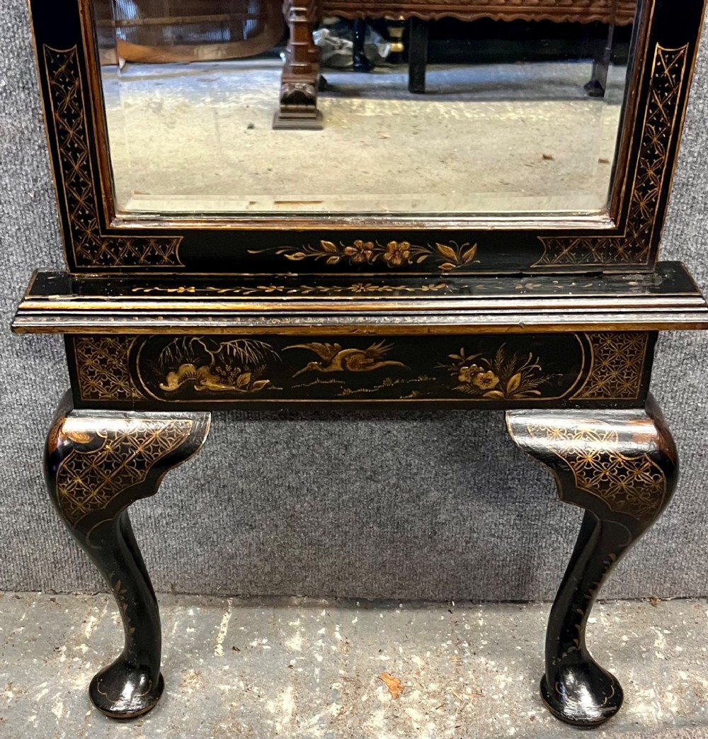 A tall, narrow black lacquered hall mirror decorated with gilded Chinoiserie pagodas and figures, featuring an arched top and front cabriole legs. View III