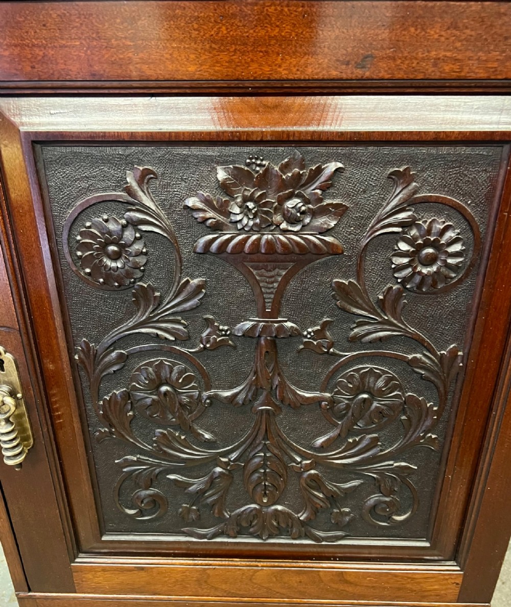 A Victorian mahogany cabinet with an open door revealing an internal Cyrus Price and Company iron safe above two lower drawers. View V