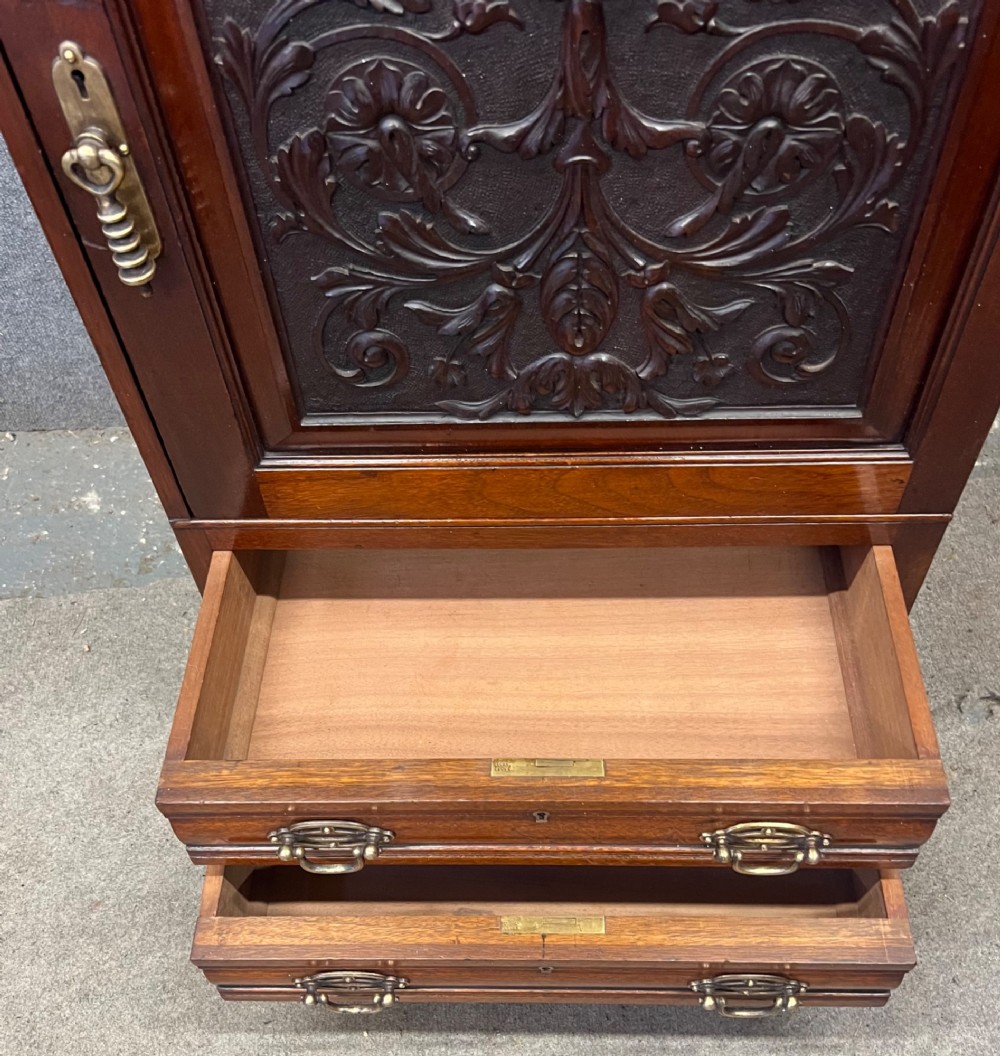 A Victorian mahogany cabinet with an open door revealing an internal Cyrus Price and Company iron safe above two lower drawers. View VIII