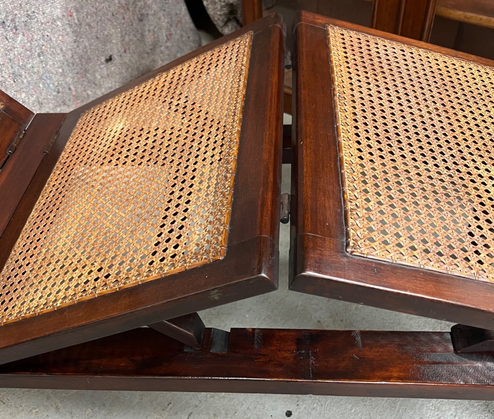 An antique mahogany campaign bed featuring three hinged folding sections with woven cane panelling and a dark timber frame. View VIII