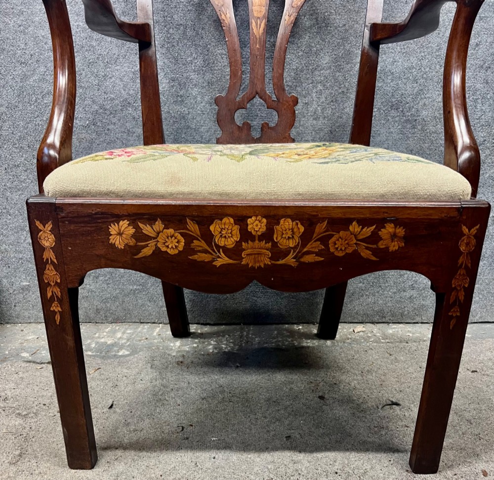 An antique mahogany armchair featuring floral marquetry wood inlays throughout the frame and splat, fitted with a floral needlepoint upholstered seat. View X