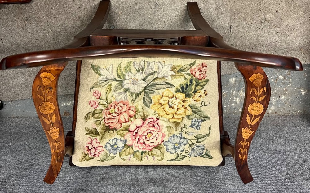 An antique mahogany armchair featuring floral marquetry wood inlays throughout the frame and splat, fitted with a floral needlepoint upholstered seat. View XI
