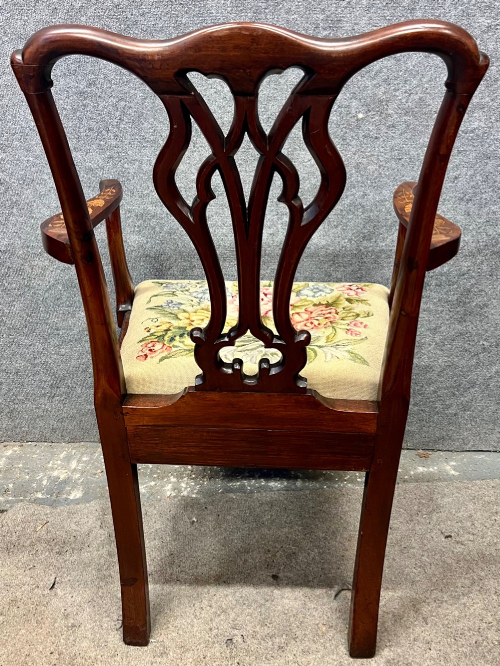 An antique mahogany armchair featuring floral marquetry wood inlays throughout the frame and splat, fitted with a floral needlepoint upholstered seat. View XII