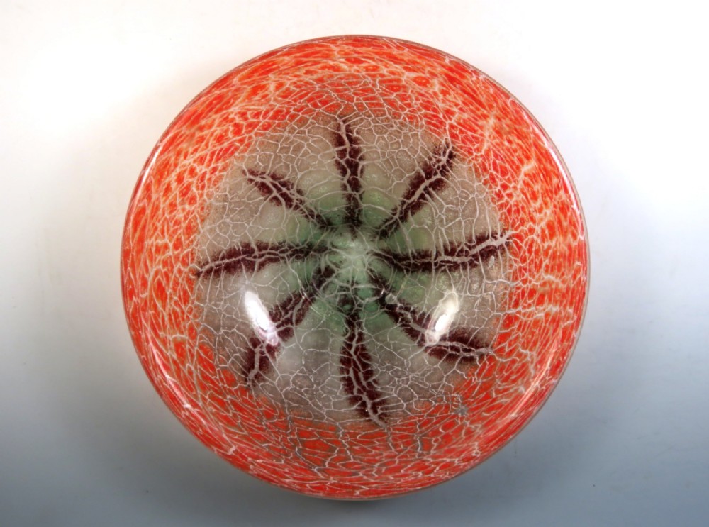 A circular Art Deco WMF Ikora glass bowl featuring a bright red crackle-effect rim and a clear centre with dark starburst inclusions. View III