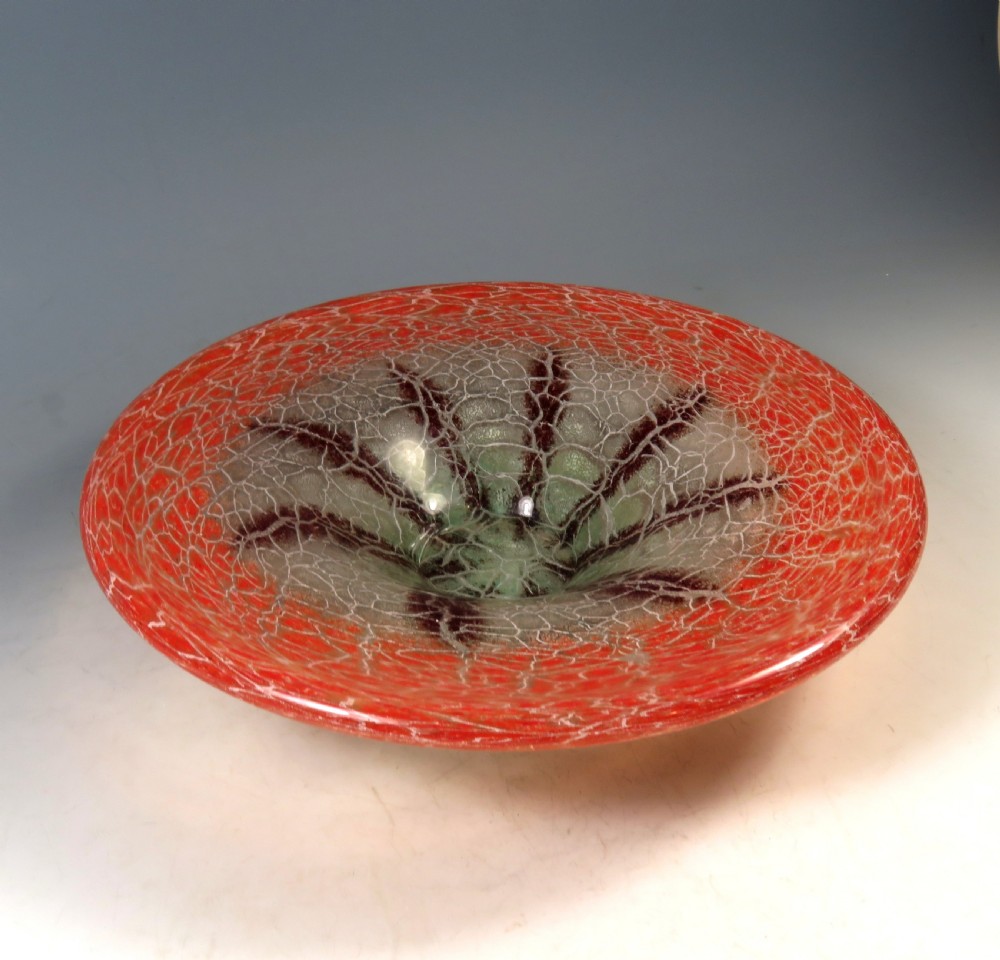 A circular Art Deco WMF Ikora glass bowl featuring a bright red crackle-effect rim and a clear centre with dark starburst inclusions. View VI