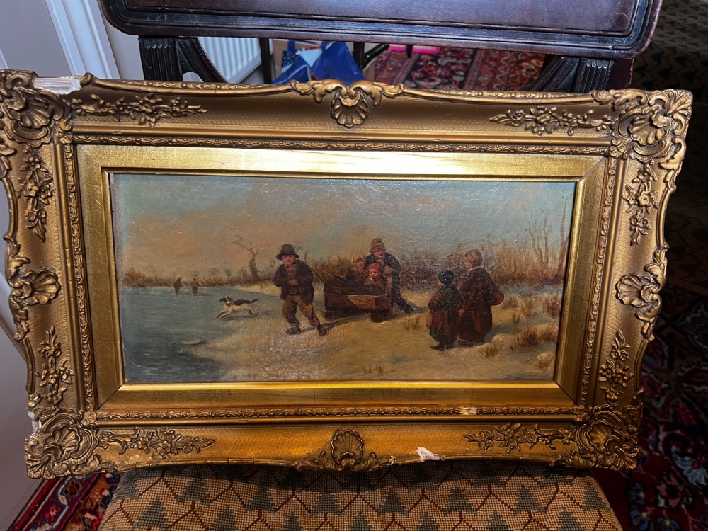 An antique Victorian oil painting featuring figures in a landscape, set within an ornate, heavily carved gold-gilt frame.