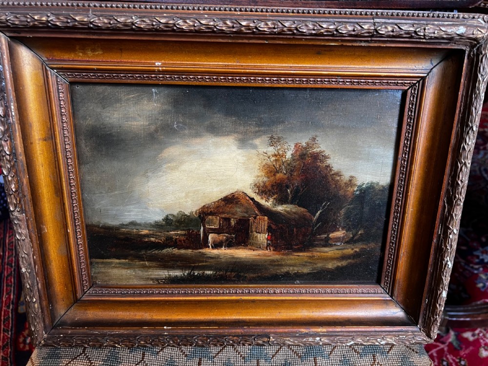 An antique oil painting on canvas depicting a rustic rural landscape with a thatched barn and livestock. View II