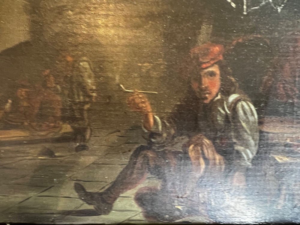 A Victorian oil painting on board depicting a seated man smoking a pipe in a tavern setting, framed in molded gilt wood. View II