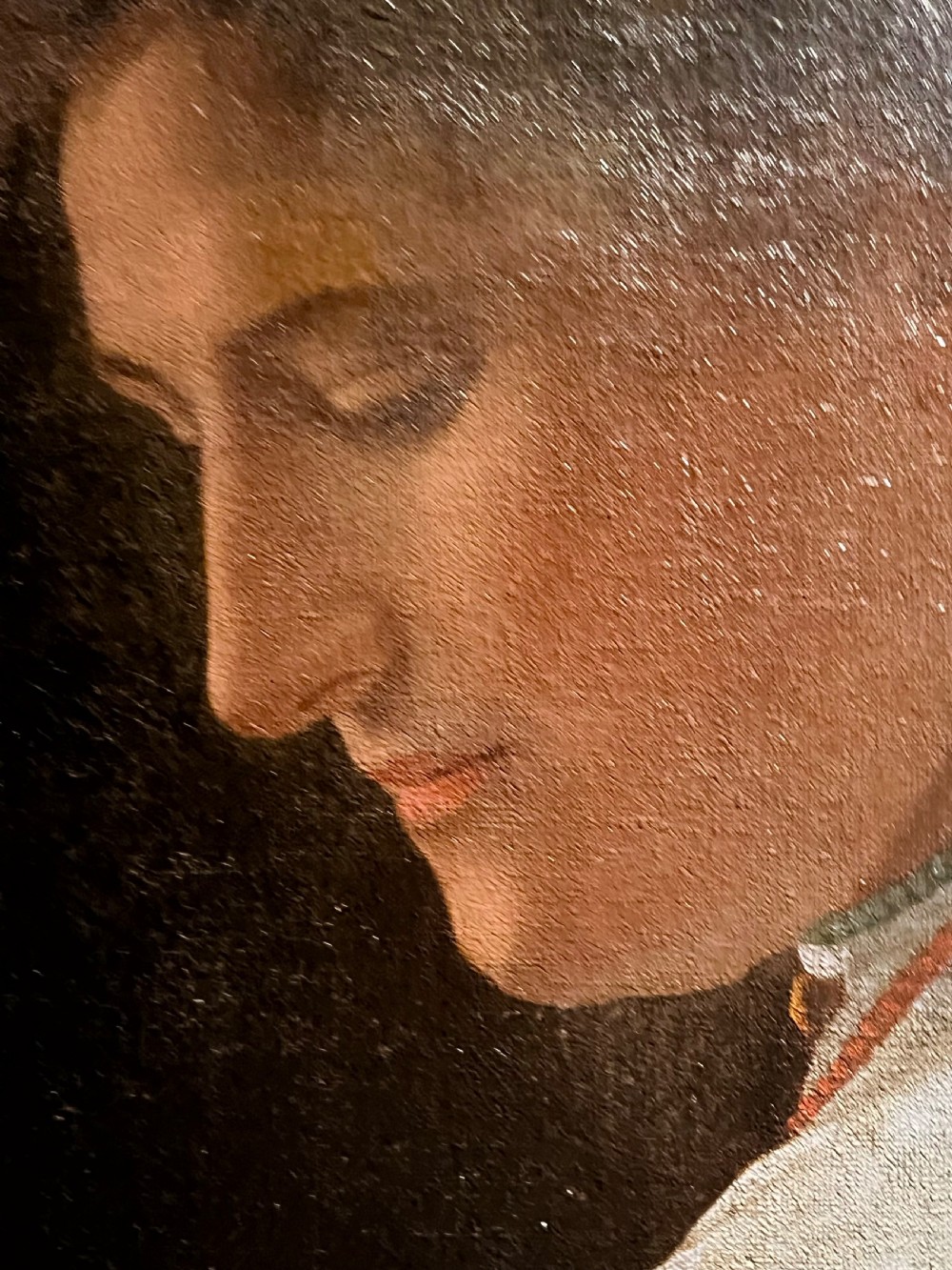 A 19th-century English School oil painting depicting a profile portrait of a woman wearing a pleated cream dress, housed within a moulded gilt wood frame. View II