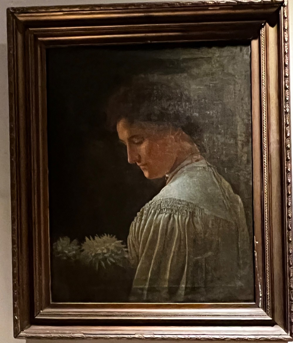 A 19th-century English School oil painting depicting a profile portrait of a woman wearing a pleated cream dress, housed within a moulded gilt wood frame. View V