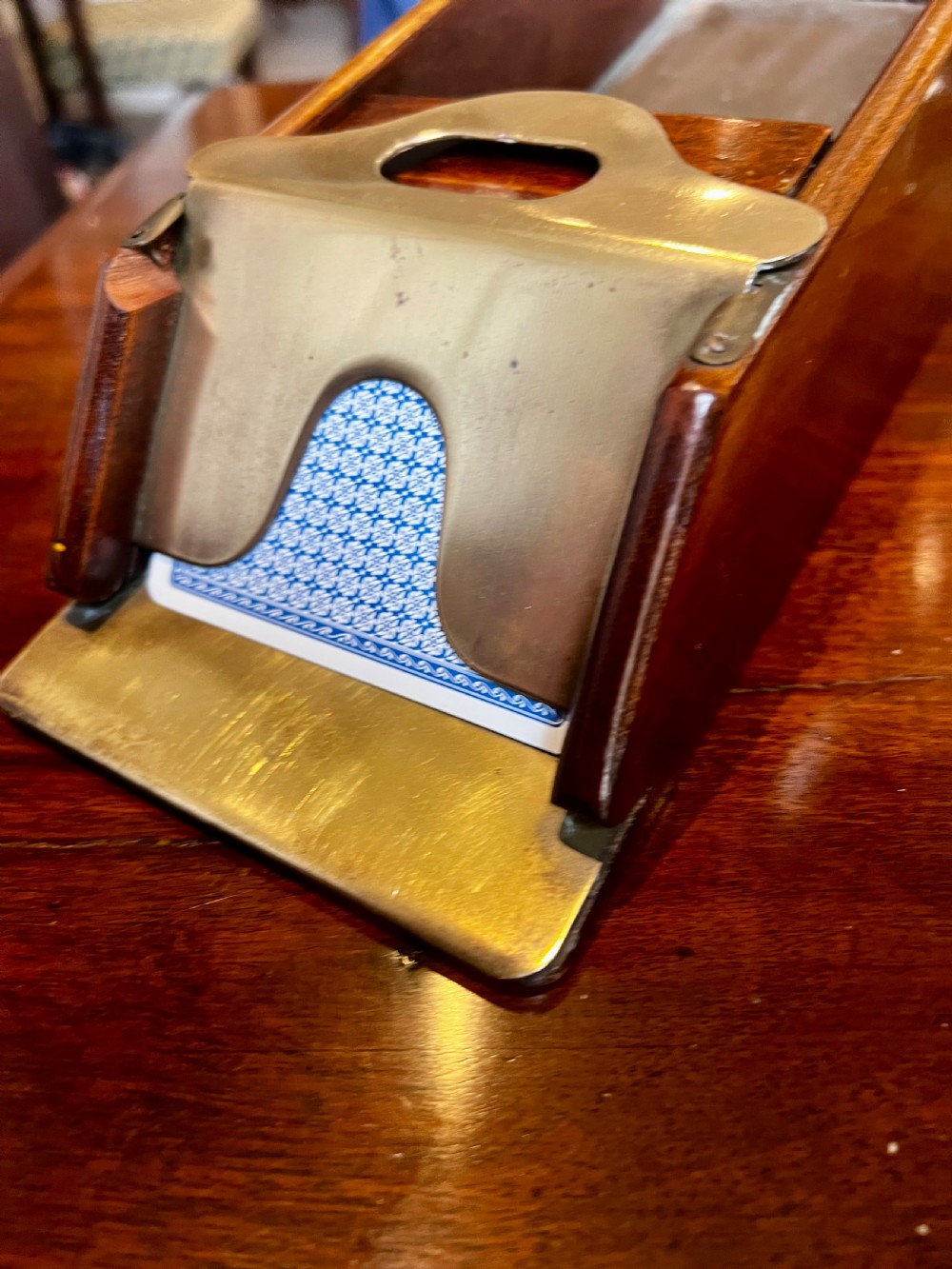 A vintage mahogany card shoe featuring a brass weighted dispensing mechanism and exposed grain. View IV