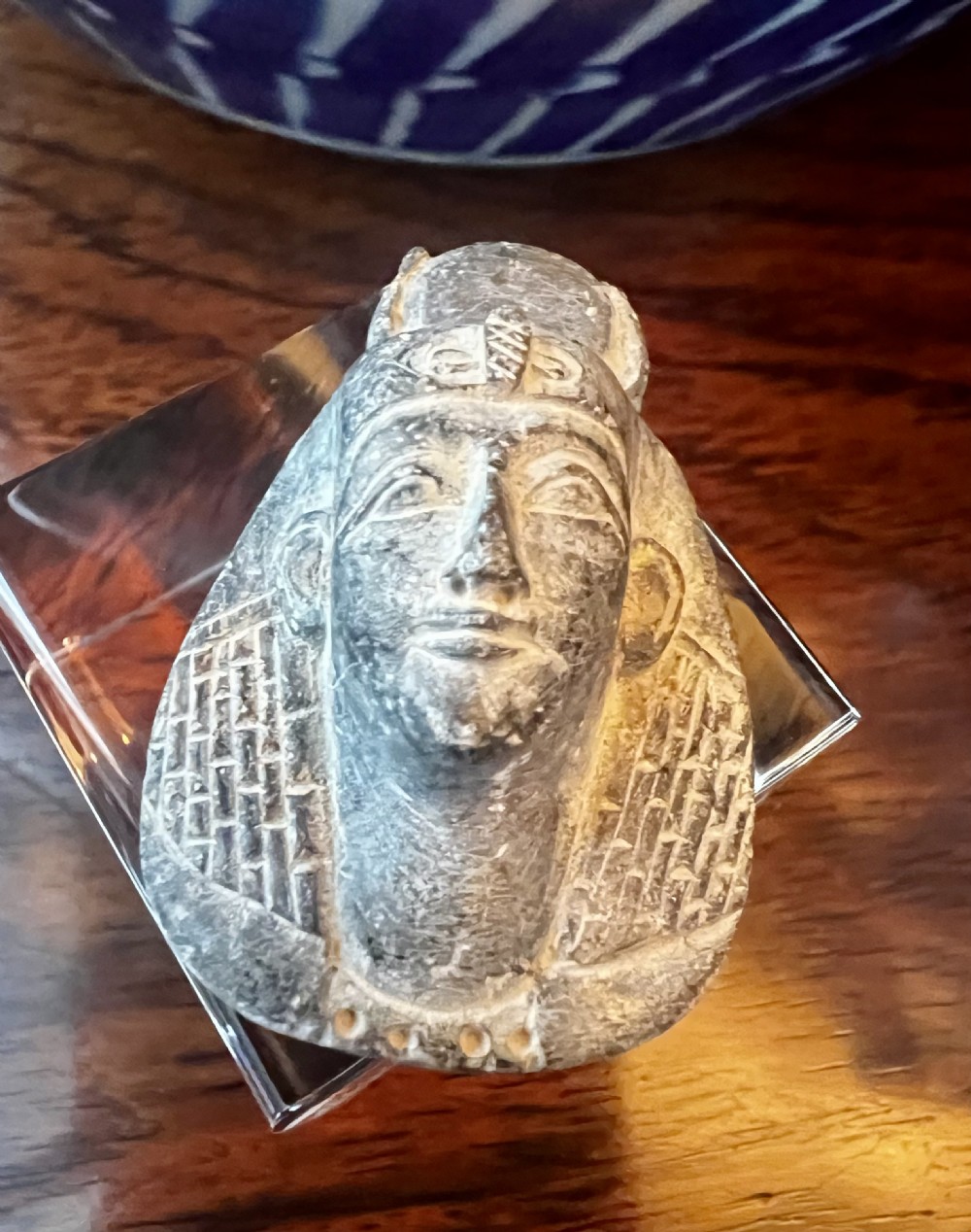 Four carved grey stone Egyptian scarabs and deity figurines displayed individually on clear acrylic block stands. View III