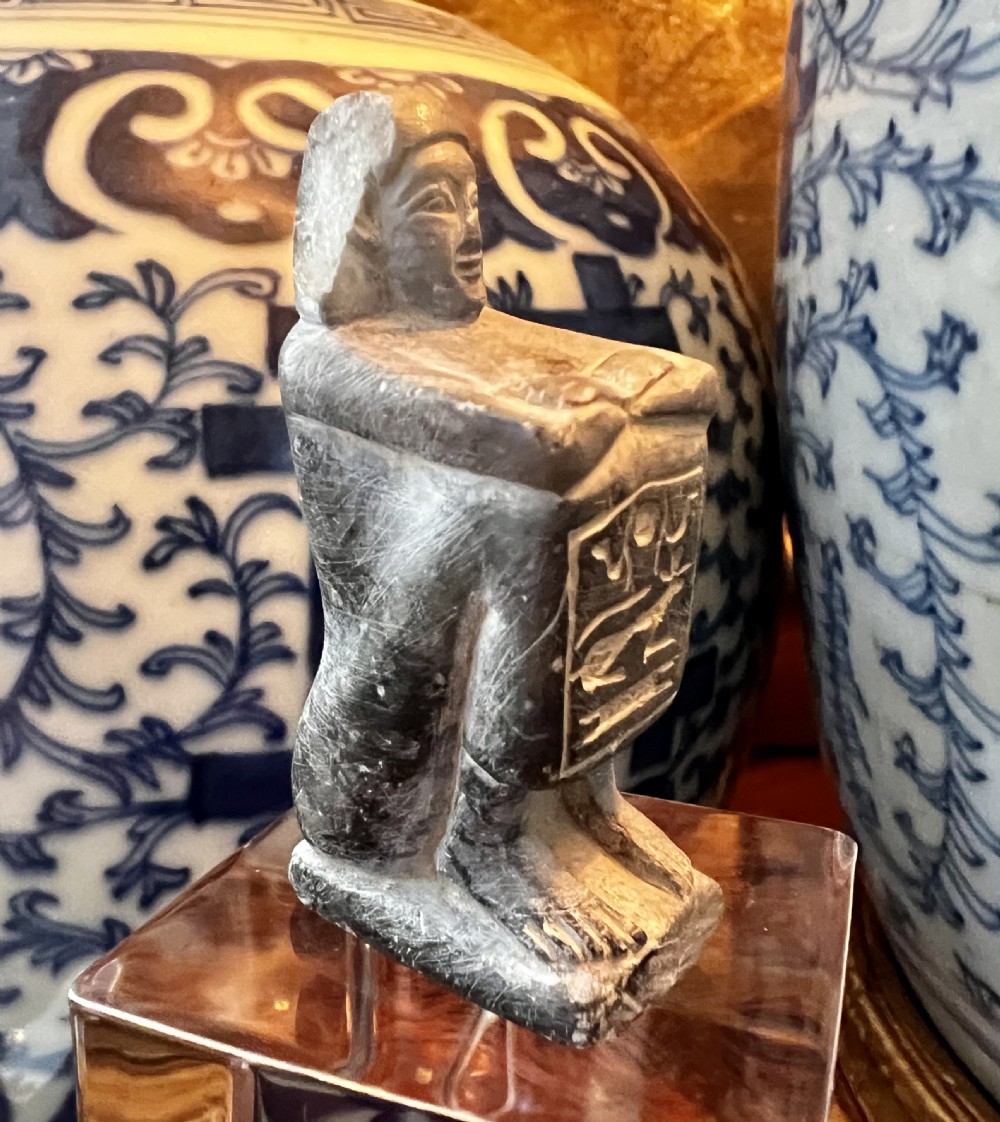 Four carved grey stone Egyptian scarabs and deity figurines displayed individually on clear acrylic block stands. View IV