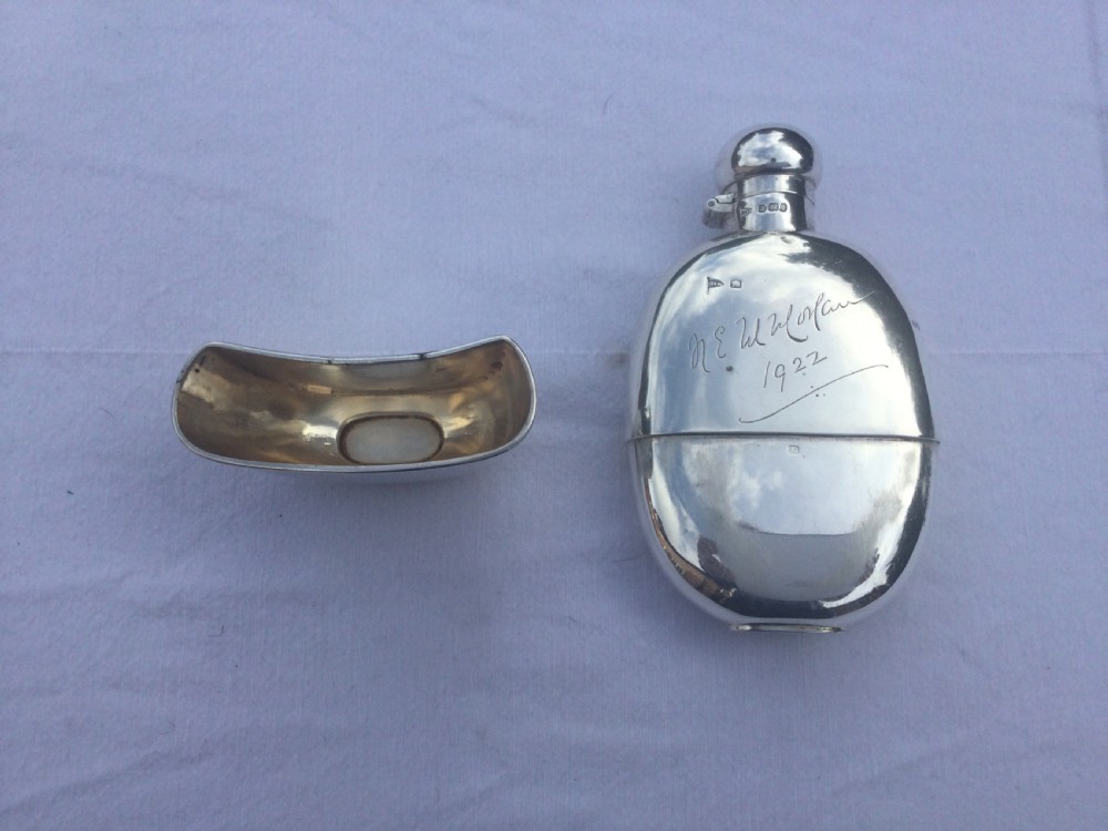 A curved silver hip flask featuring an engraved signature dated 1922, hallmarked collar, and a hinged domed cap. View III