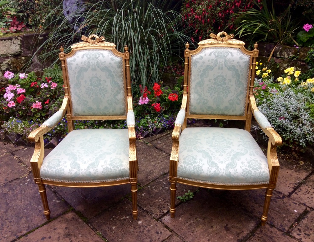 pair of Edwardian giltwood armchairs.