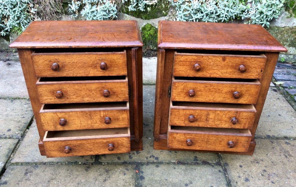 A pair of miniature oak chest of drawers View II