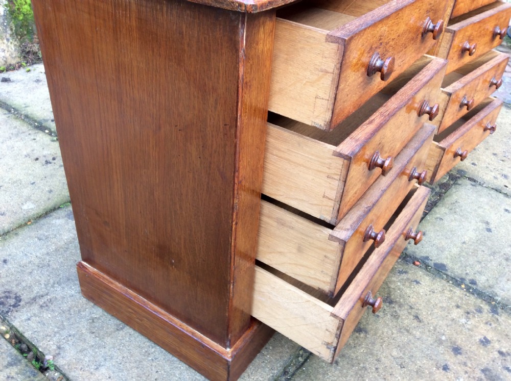 A pair of miniature oak chest of drawers View V