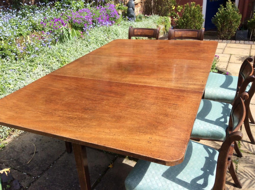 A large drop leaf mahogany dining  table