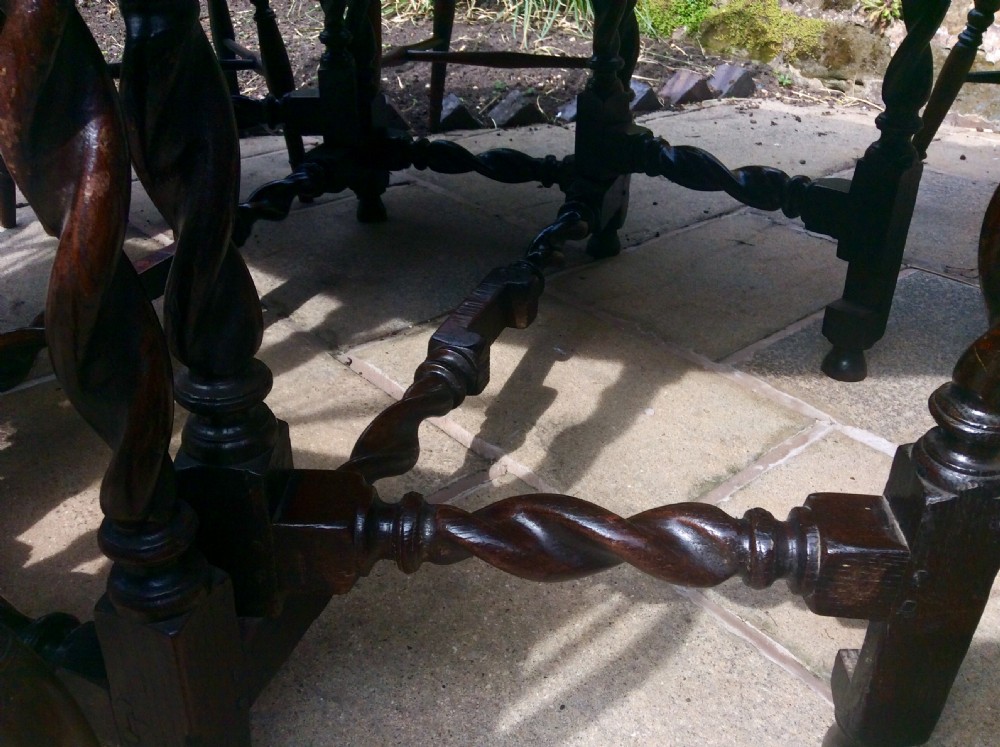 An antique dark oak oval gateleg table featuring barley twist turned legs, stretchers, and folding drop leaves. View VIII