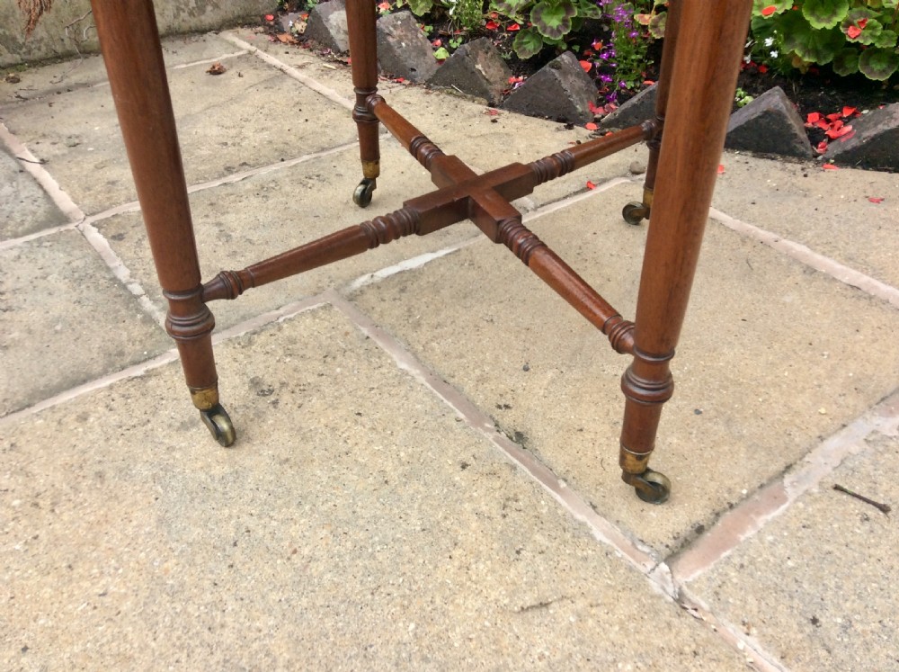 A Regency mahogany Pembroke table featuring two drawers, drop-leaf sides, turned reeded legs, a cross-stretcher, and brass castors. View IX