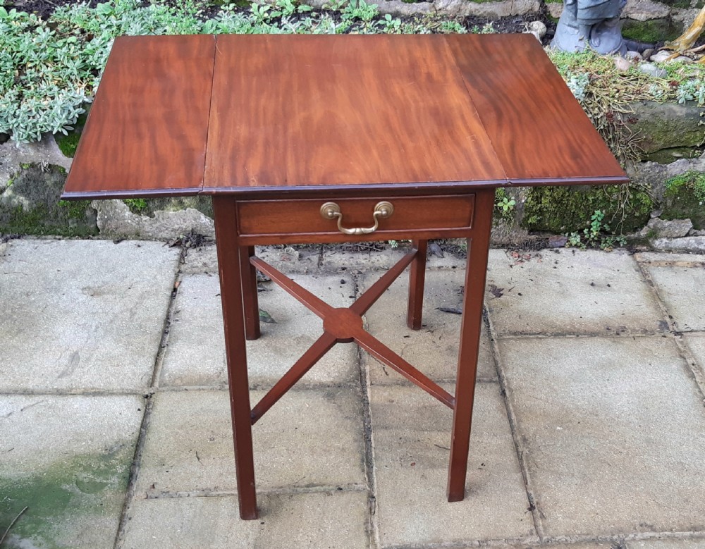 A small mahogany Pembroke side table featuring two drop leaves, a single drawer with a brass handle, square tapered legs, and an X-frame stretcher. View II