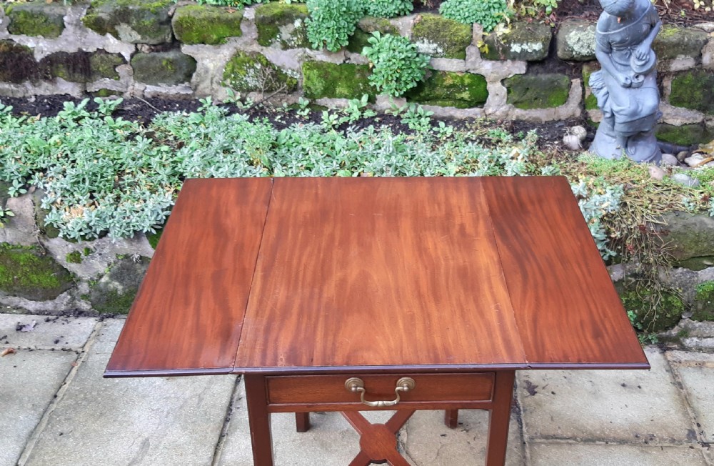 A small mahogany Pembroke side table featuring two drop leaves, a single drawer with a brass handle, square tapered legs, and an X-frame stretcher. View III