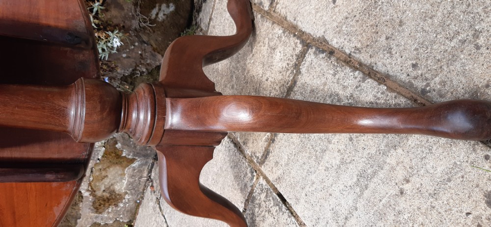 A Georgian circular mahogany tripod table featuring a turned central pedestal and three cabriole legs. View V