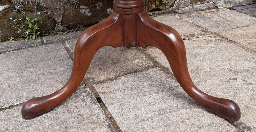 A Georgian circular mahogany tripod table featuring a turned central pedestal and three cabriole legs. View VI