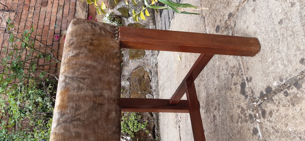 An upholstered rectangular mahogany stool featuring patterned brown fabric with stud detailing and straight legs joined by an H-stretcher. View IV