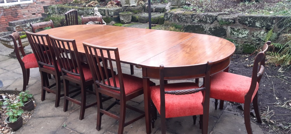 A large Georgian mahogany extending dining table featuring modular leaves and square tapered legs. View VII