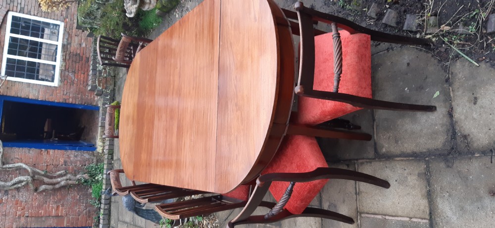 A large Georgian mahogany extending dining table featuring modular leaves and square tapered legs. View VIII