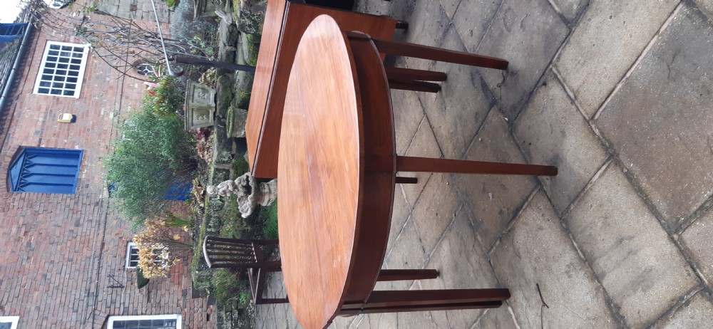 A large Georgian mahogany extending dining table featuring modular leaves and square tapered legs. View XII